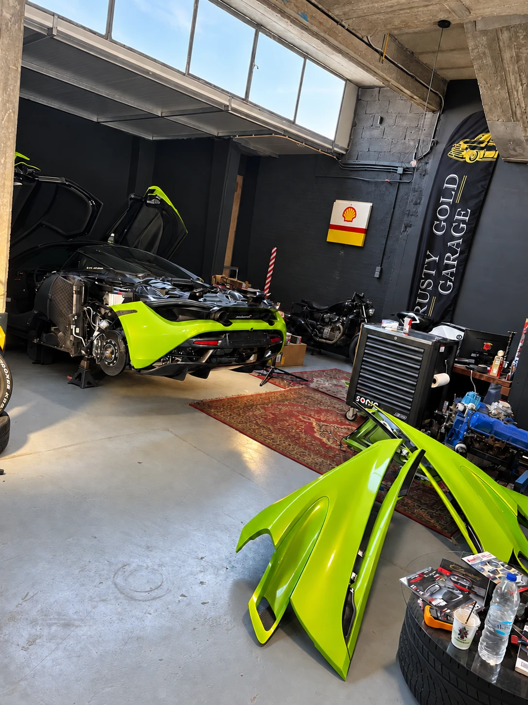 Lime green sports car during bodywork and mechanical work
