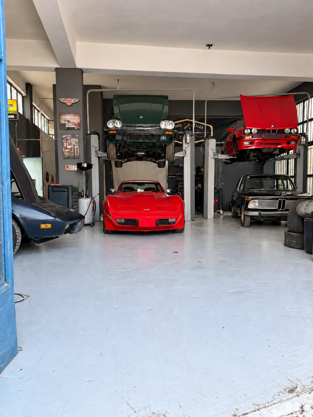 Corvette, Jaguar and BMW cars in the service bays