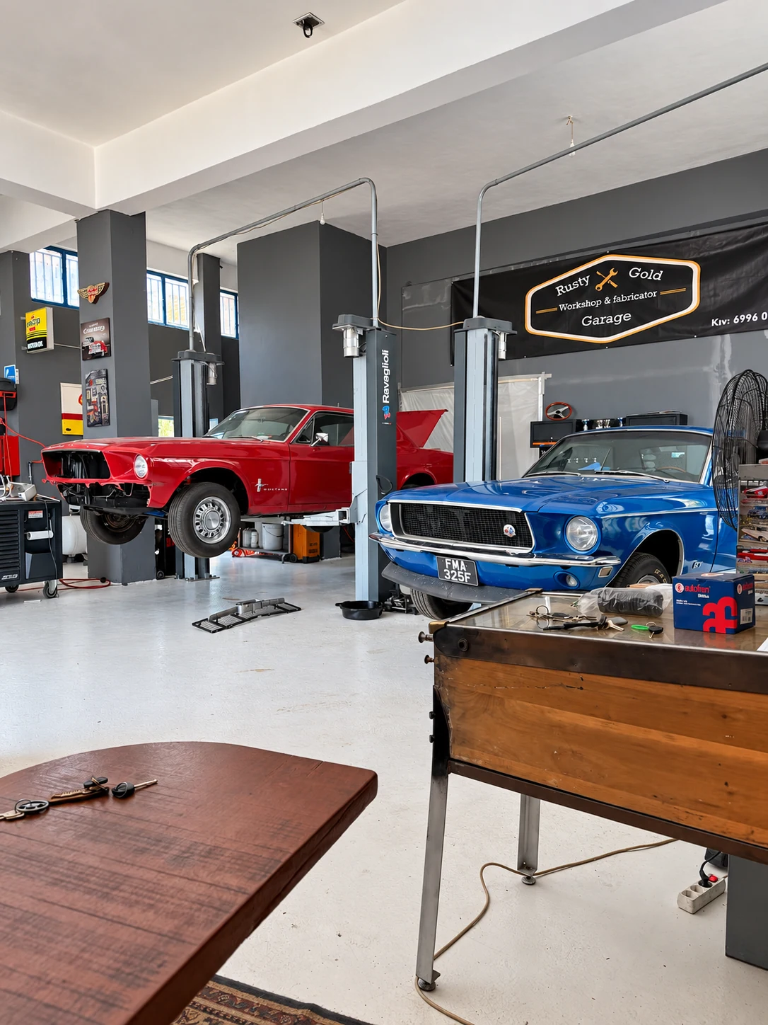 Red and blue classic Mustangs inside Rusty Gold Garage